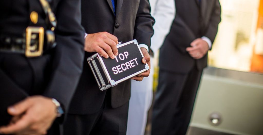 man holding top secret briefcase